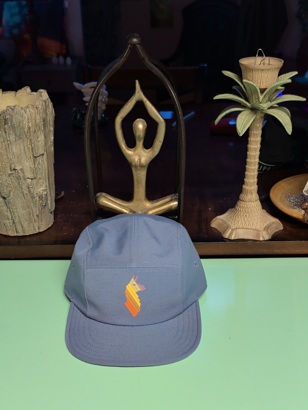 cotopaxi light blue five-panel hat with multicolor striped llama logo